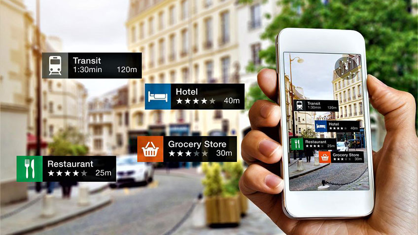 A person holding a smartphone displaying an augmented reality map showing various locations and their distances, including a restaurant, hotel,…