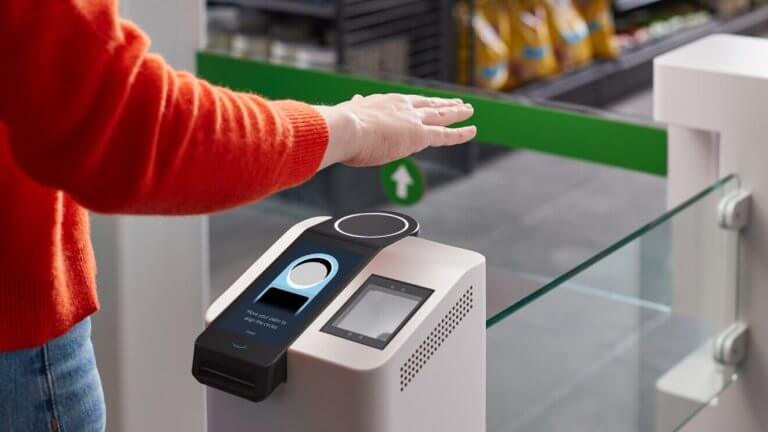 A person interacting with a self-service kiosk in a store.