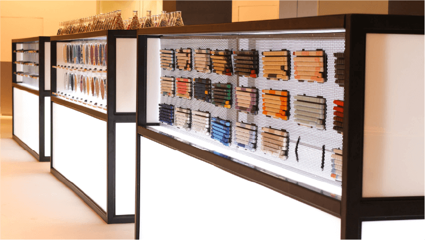 A long black shelf displaying an assortment of books in a store.