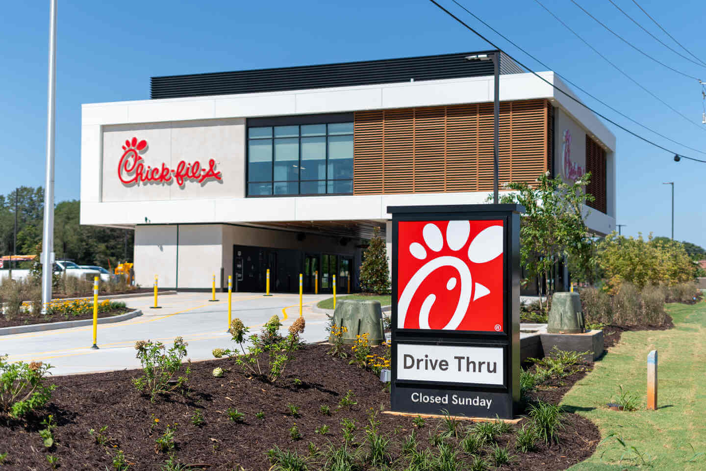 Chick-fil-a restaurant with drive through sign, located in a suburban area.