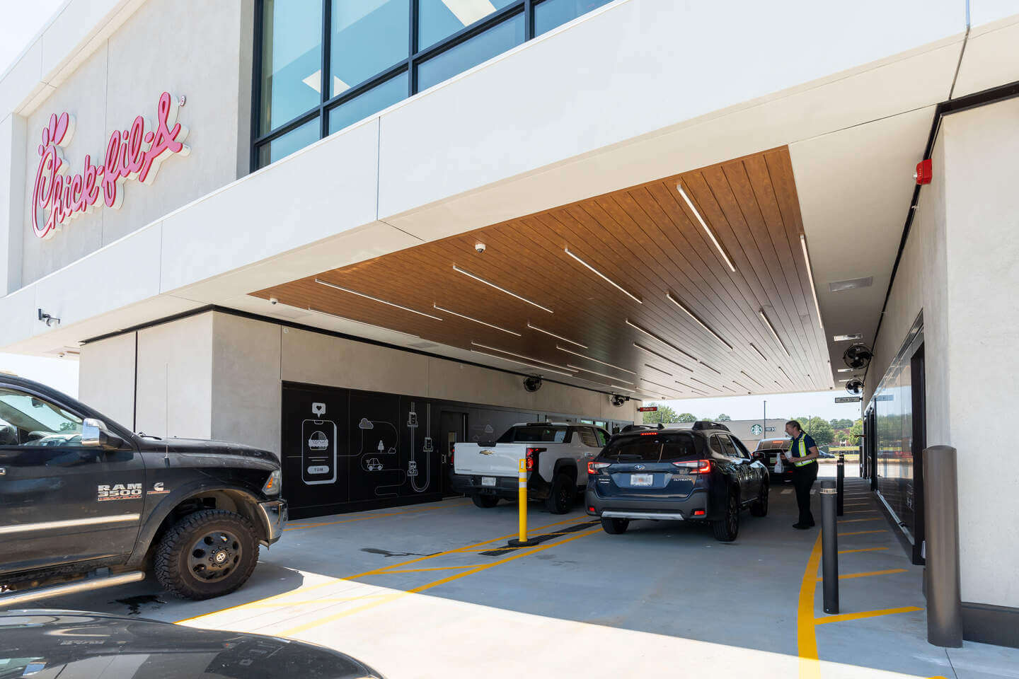 A car dealership covered by an overhang.