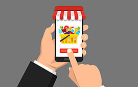 A hand holding a smartphone displaying an advertisement for a store sale, with the phone showing a colorful graphic and text.