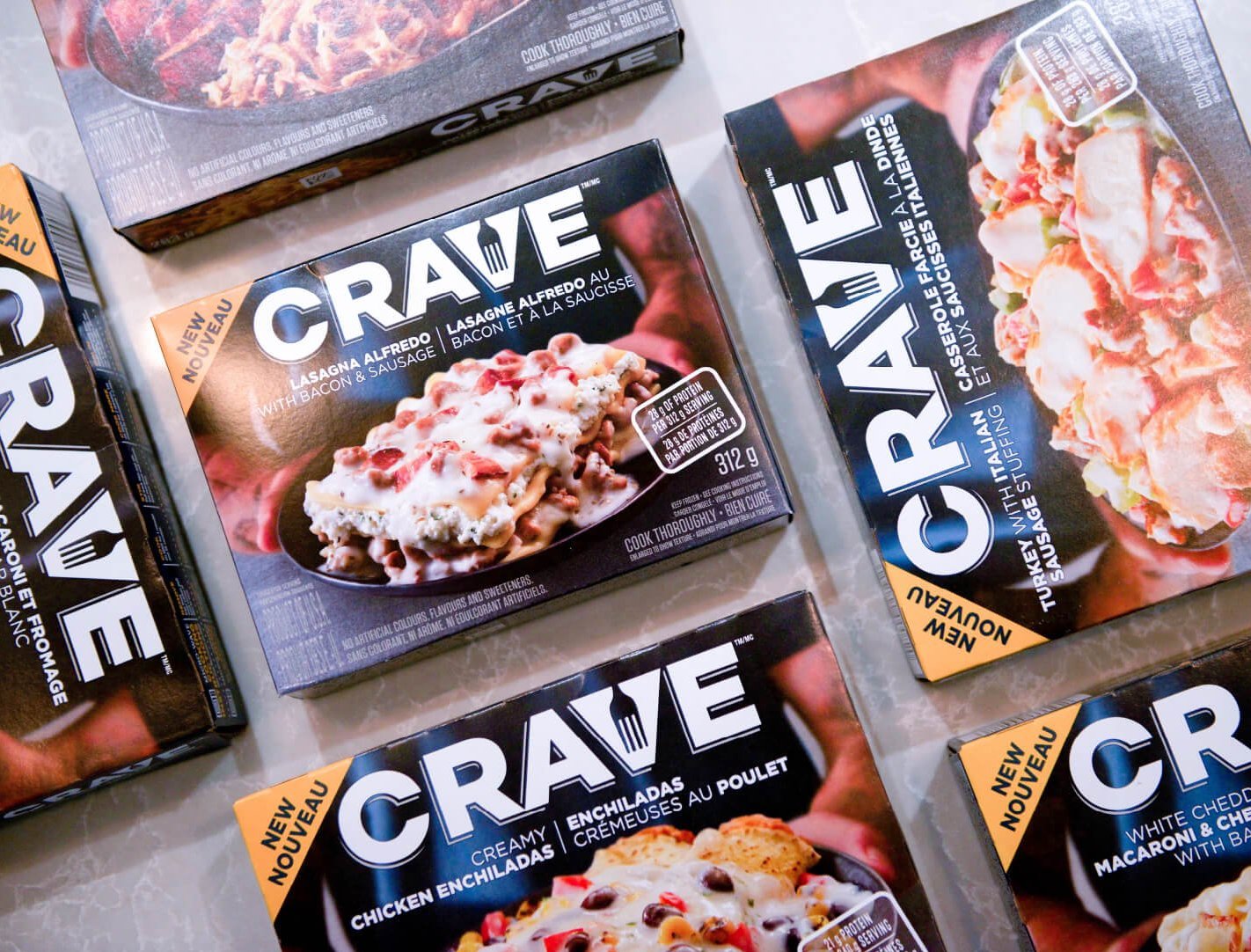 Six boxes of Crave frozen pizza, with flavors including "CRAVE" and "CRUMPLE".