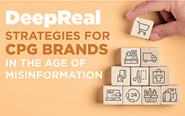 A hand holding a block from the game Jenga, with other blocks stacked on top. In front of the blocks, there's text that reads "DeepReal" and below…