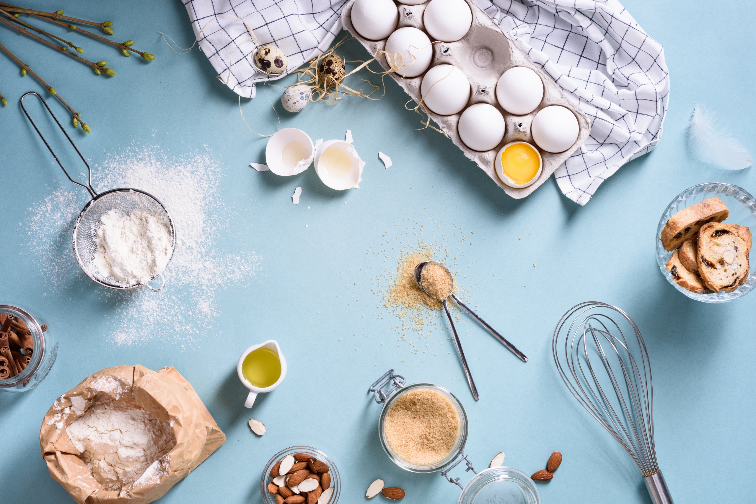 A table filled with various ingredients and kitchen utensils, ready for baking.