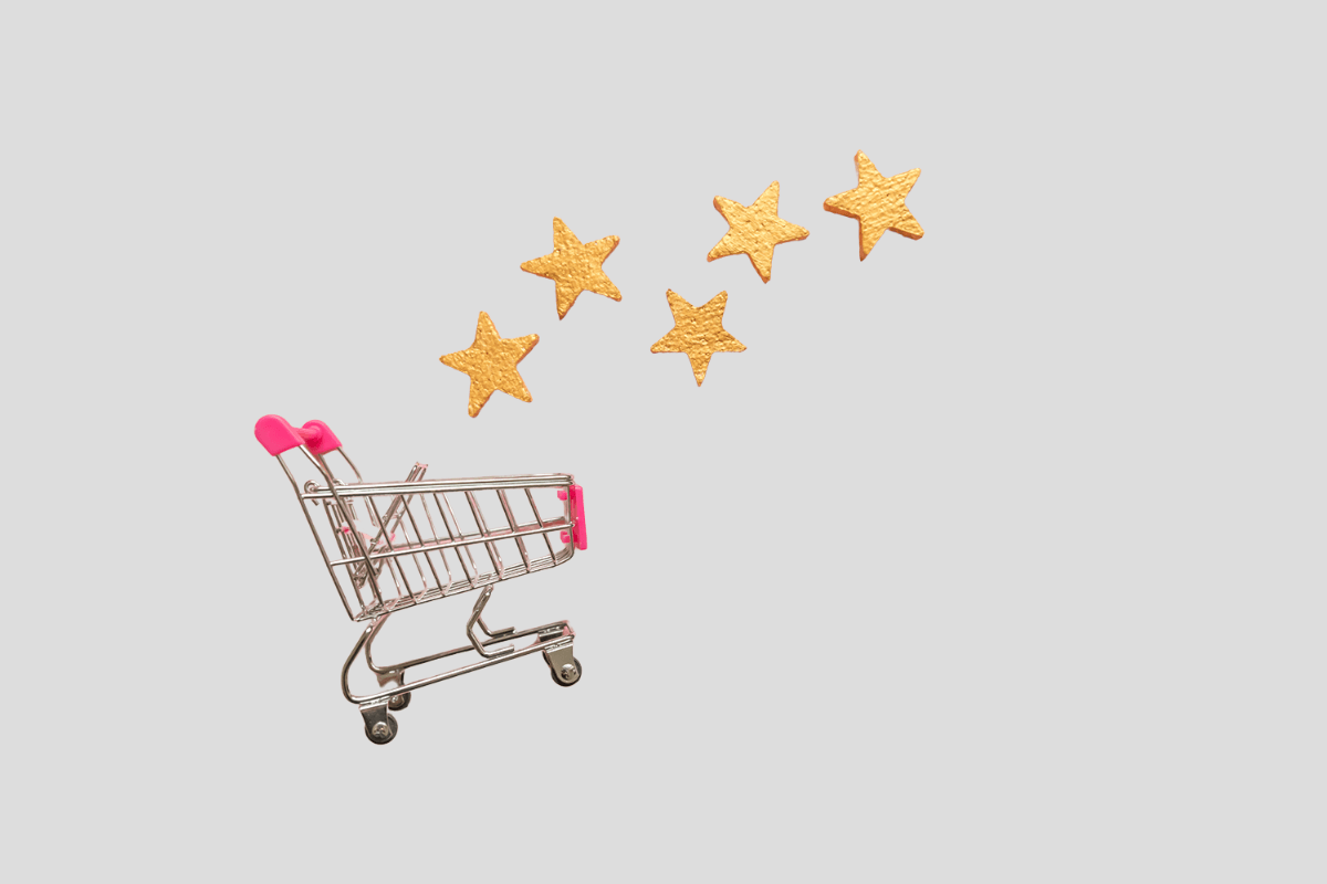 A shopping cart with stars above it, set against a plain background