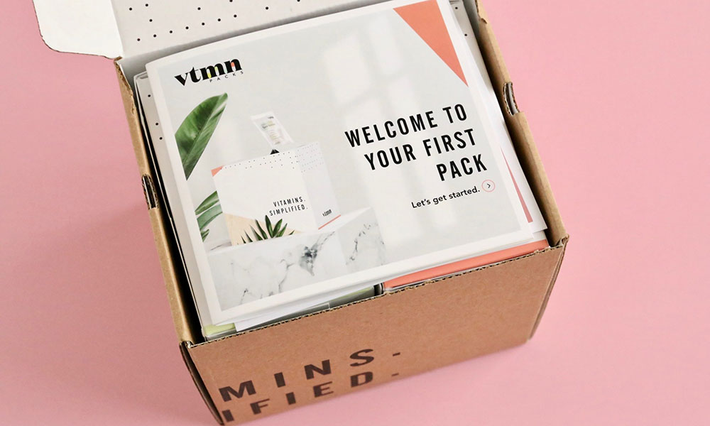 A box containing a welcome sign, a first pack, and some pamphlets.