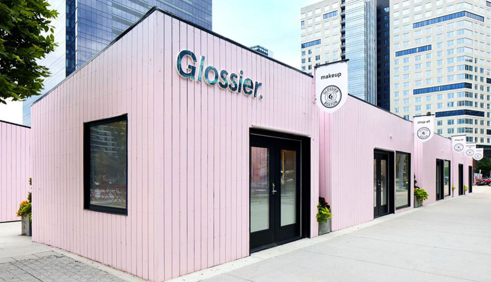 A pink building with a sign that reads