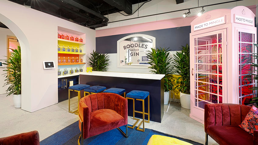 A modern indoor space with a bar, seating area, and decorative elements.