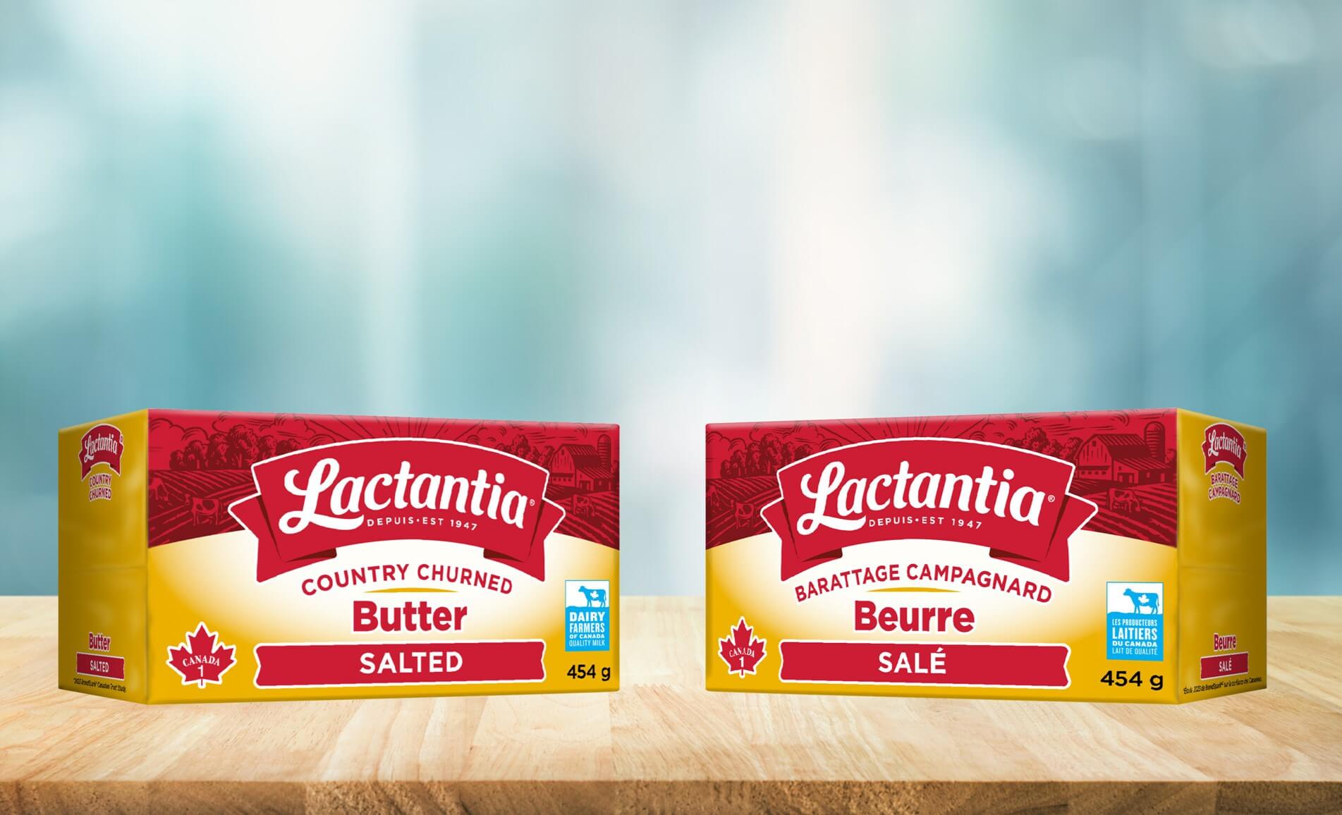 Two boxes of Lactantia butter on a wooden surface.