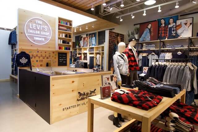 A store displaying men's clothing, including shirts, jackets, and jeans.