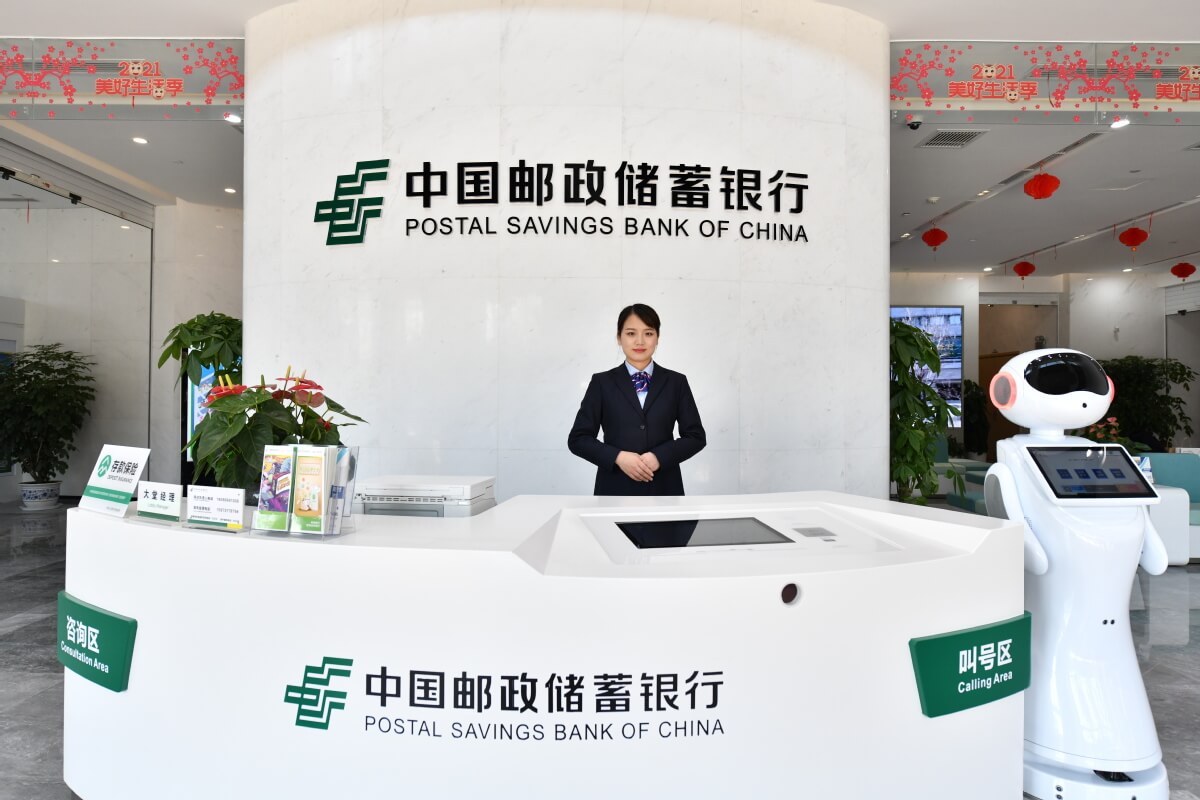 A person standing in front of a sign that reads