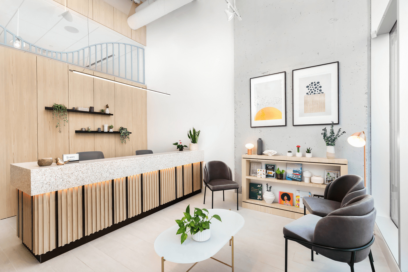 A modern interior space with a reception area, featuring a counter, seating, and decorative elements.