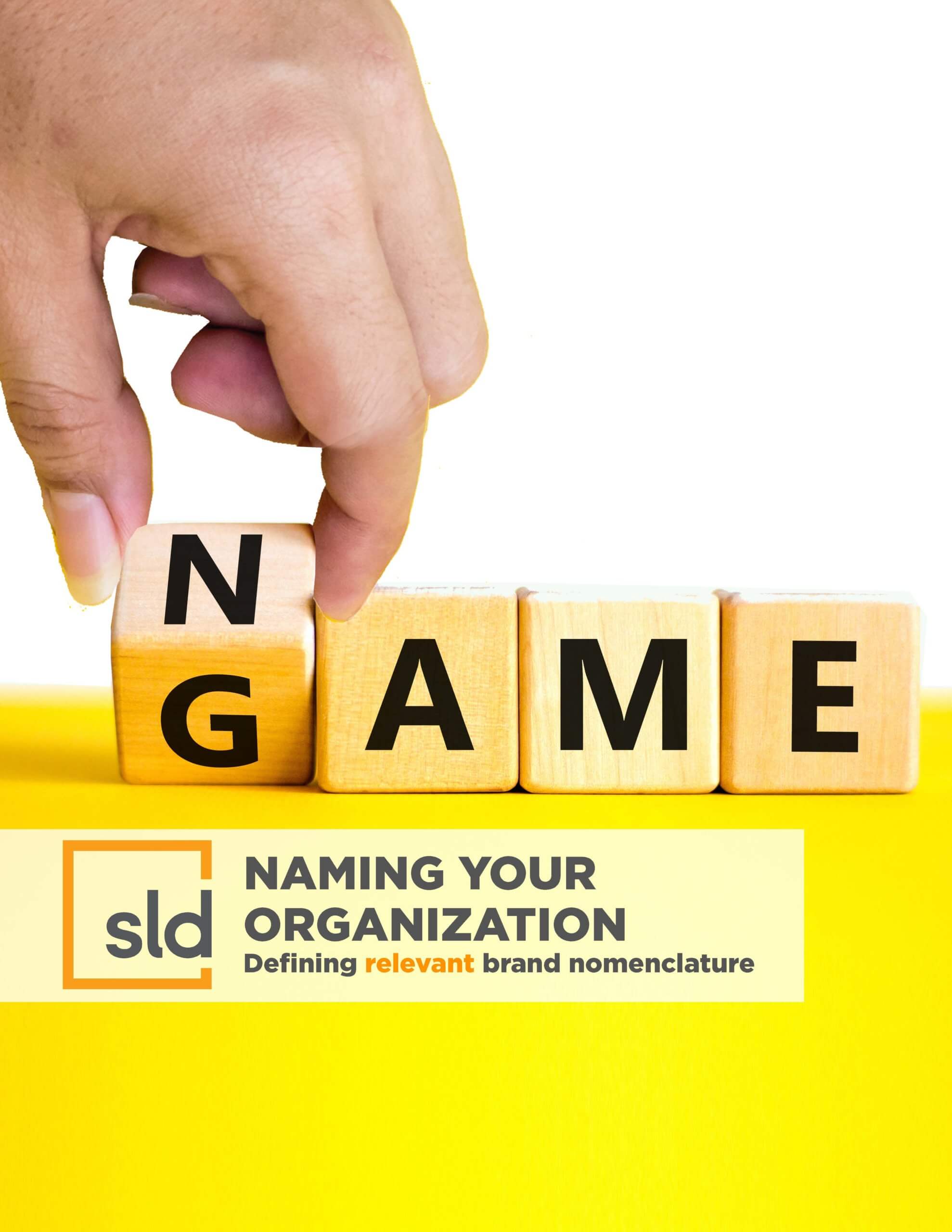 A hand holding a wooden block with the word "GAME" written on it, placed over a yellow background. Below the block, there's a text that reads…