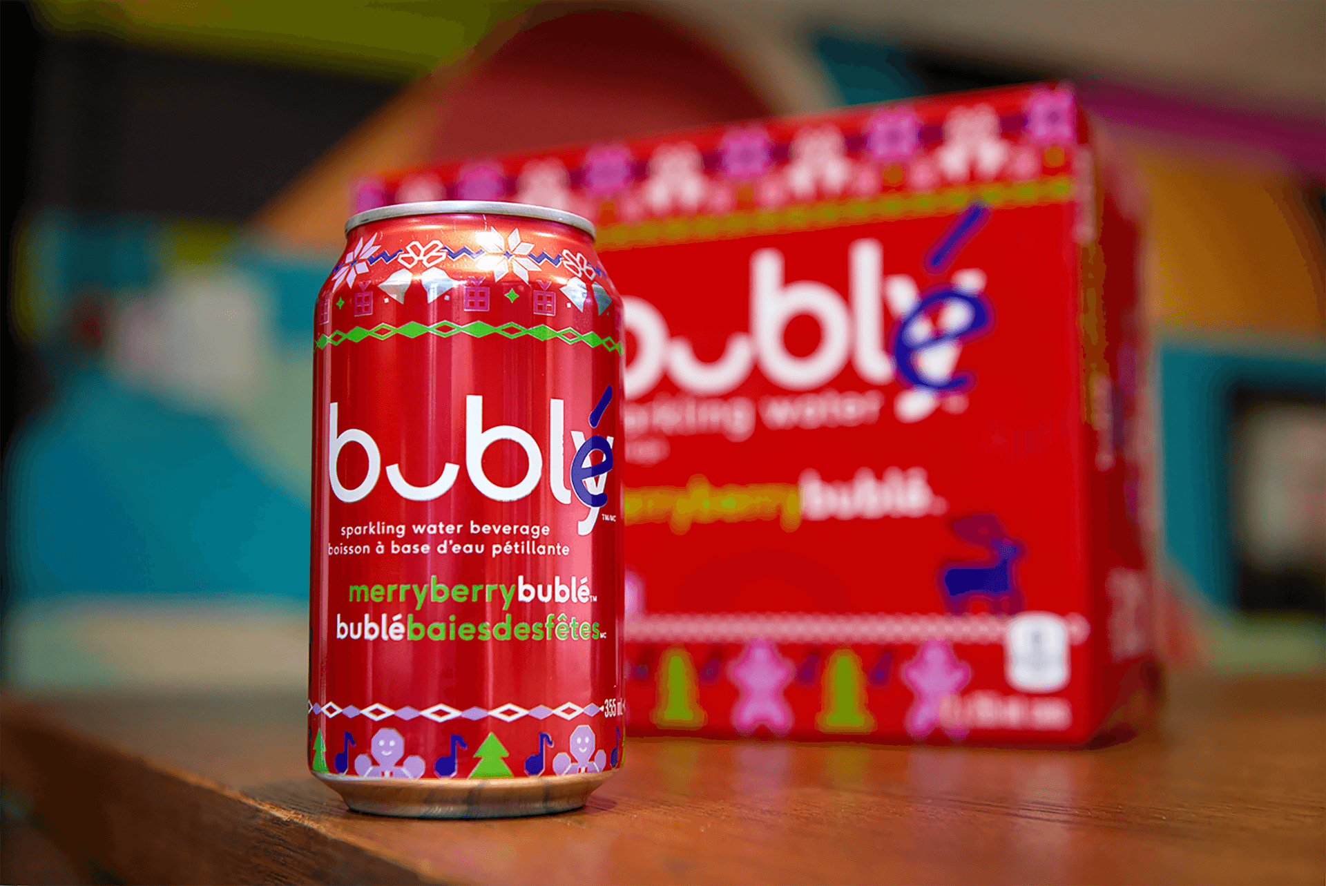 A red can of sparkling water on a table next to a box of bubble tea mix.