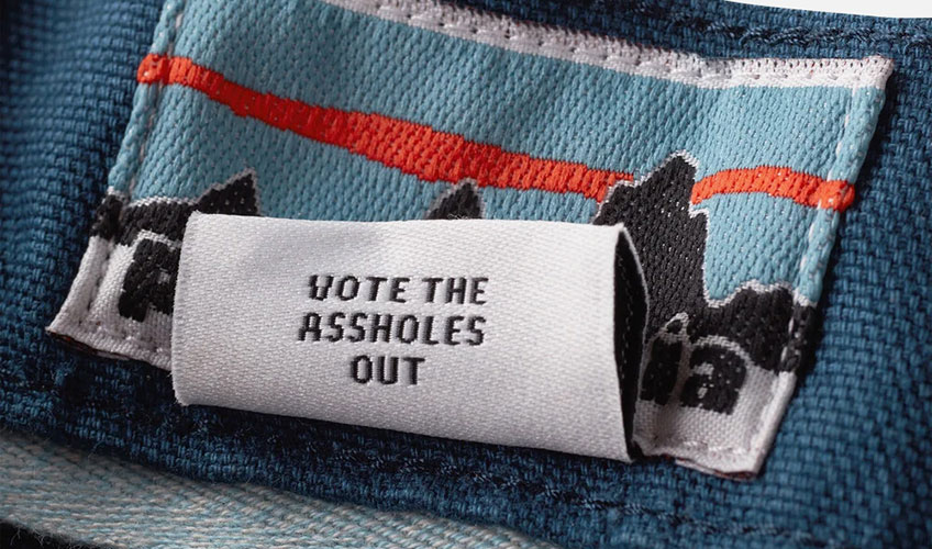A blue denim jacket with a white label that says