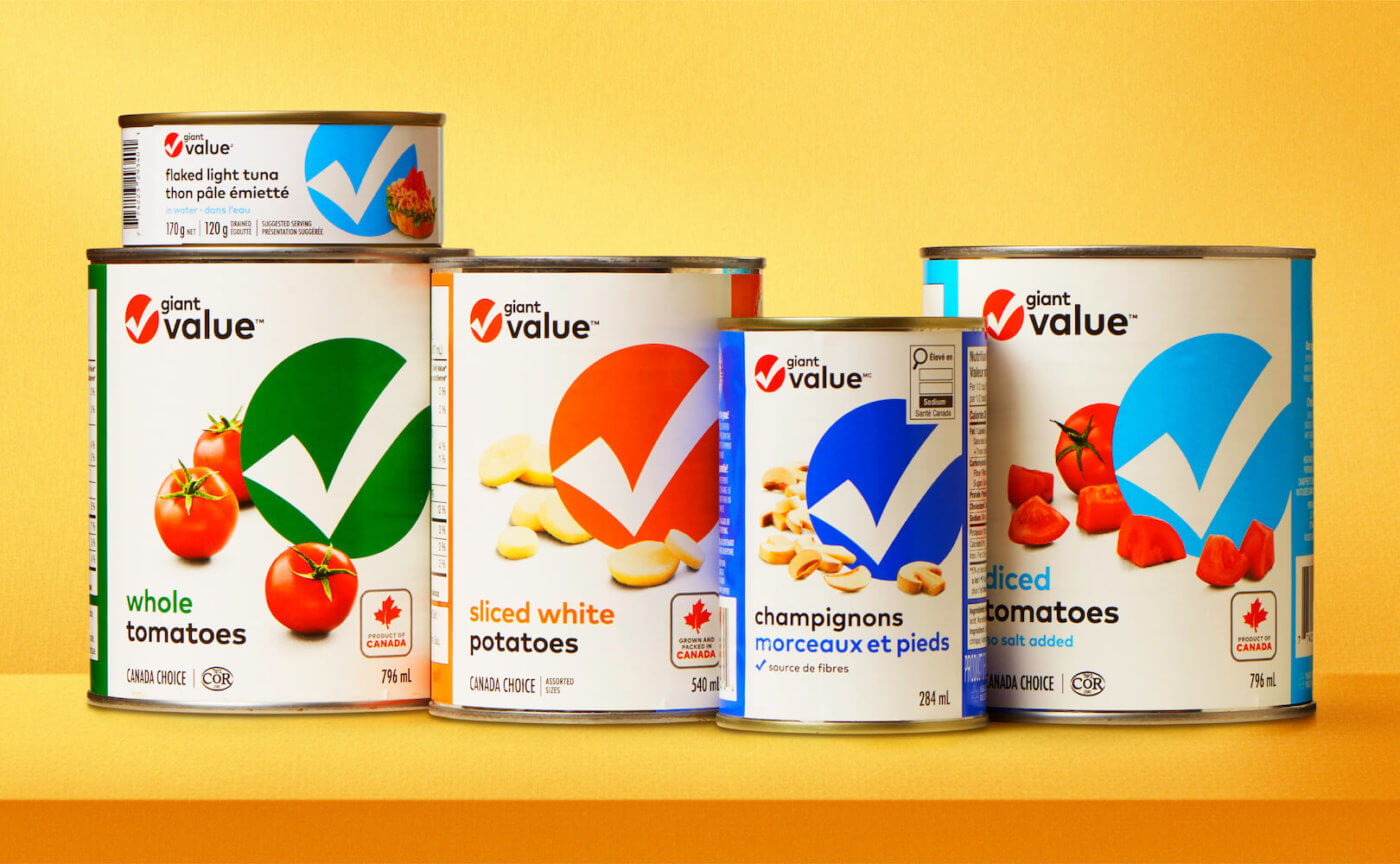 Three cans of tomatoes, one can of potatoes, all with a blue and white label.