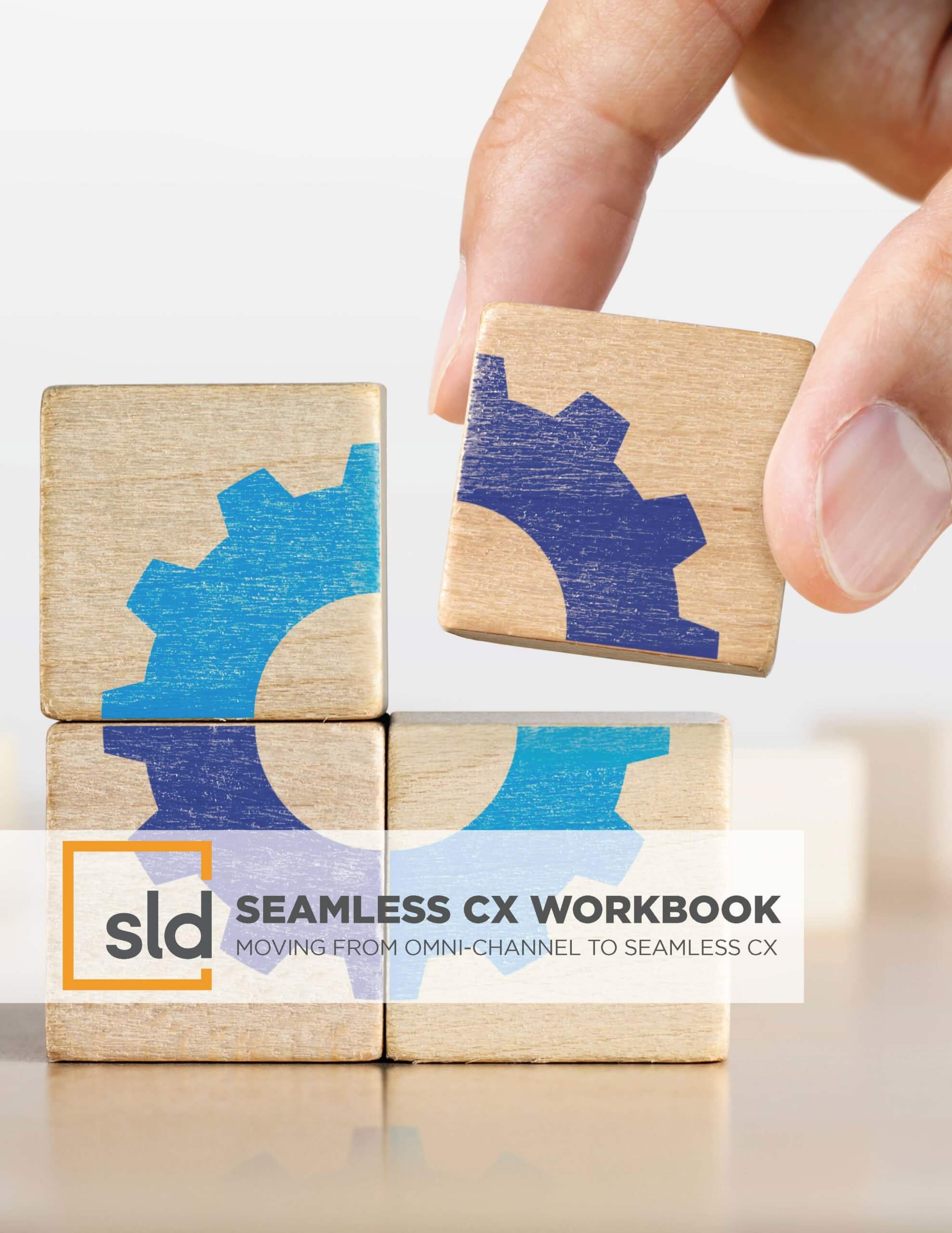 A hand holding two wooden puzzle pieces, one with a blue gear on it and the other with a white gear, symbolizing a workbook for a seamless cx…