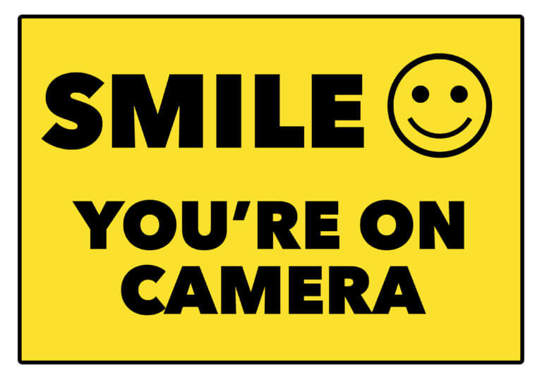 A yellow sign with black lettering that says