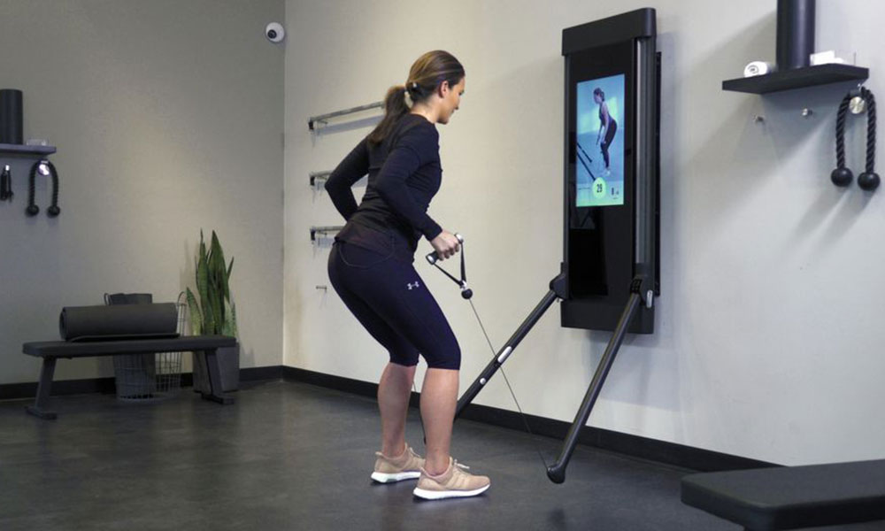Woman exercising on a treadmill in a gym.