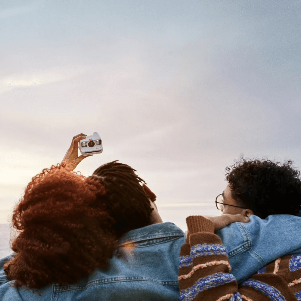 Two people taking a selfie against the sky.