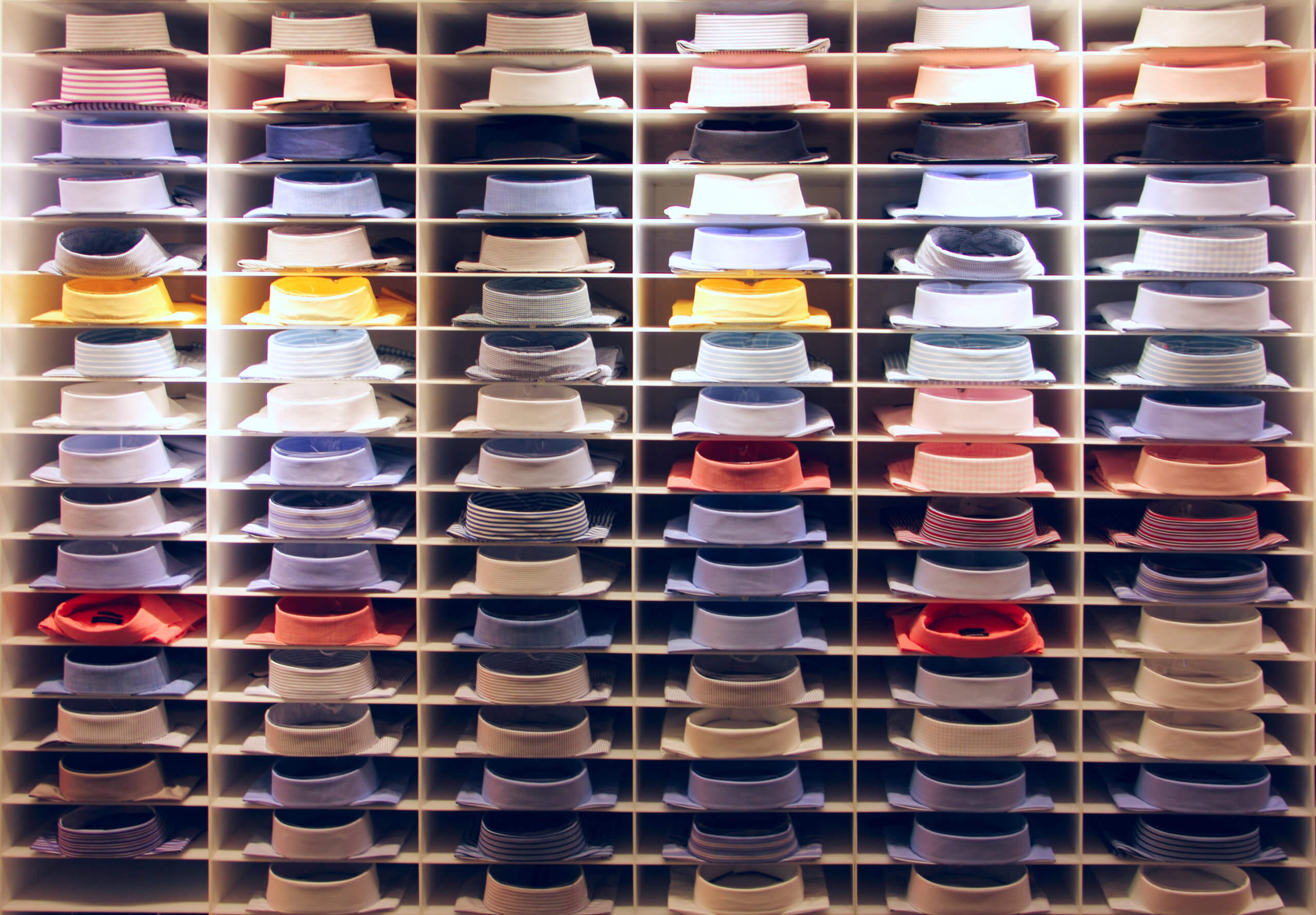 A wall displaying an assortment of ties in various colors and patterns.