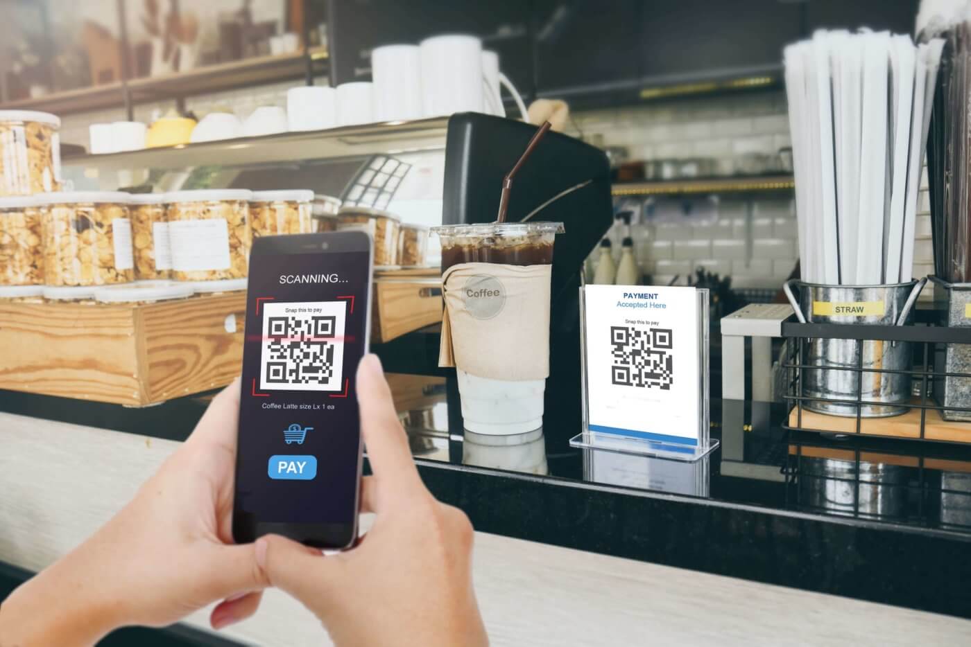 A person taking a photo of a coffee shop menu on their phone.