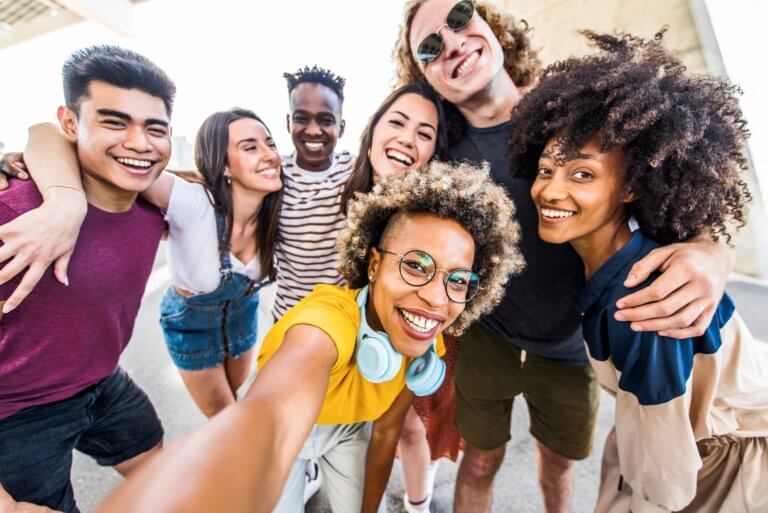 A group of young people posing for a photo, smiling and enjoying themselves.