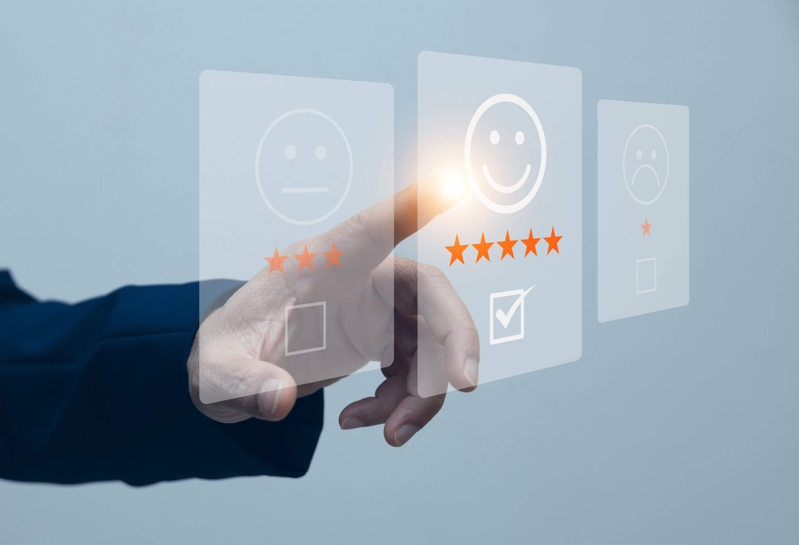 A hand pointing at an interface on a screen, displaying emojis and ratings.