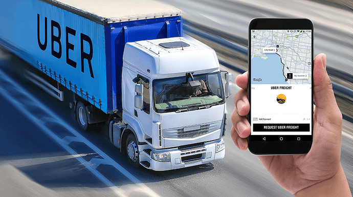 A person holding a smartphone displaying an app showing a blue truck with the word